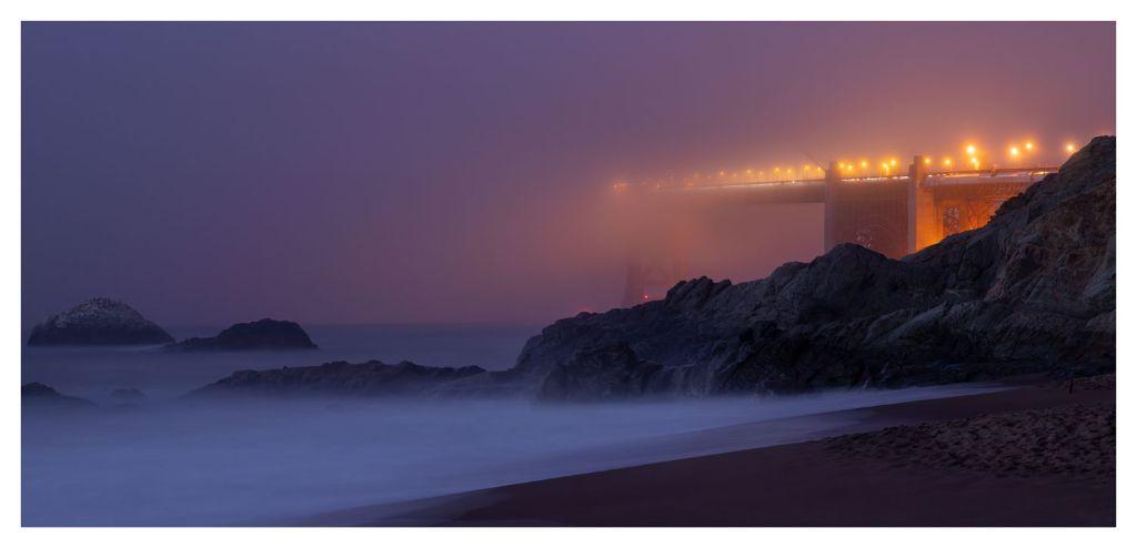 Golden Gate Bridge shrouded in fog by Michael Carpen...