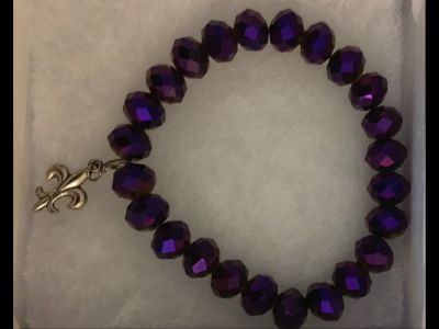 Purple iridescent beaded bracelet with Fleur-de-lis charm.