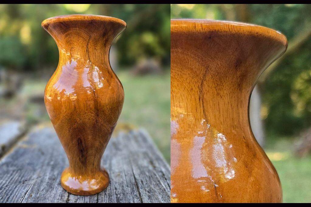 Slender yellow wooden vase, glossy.