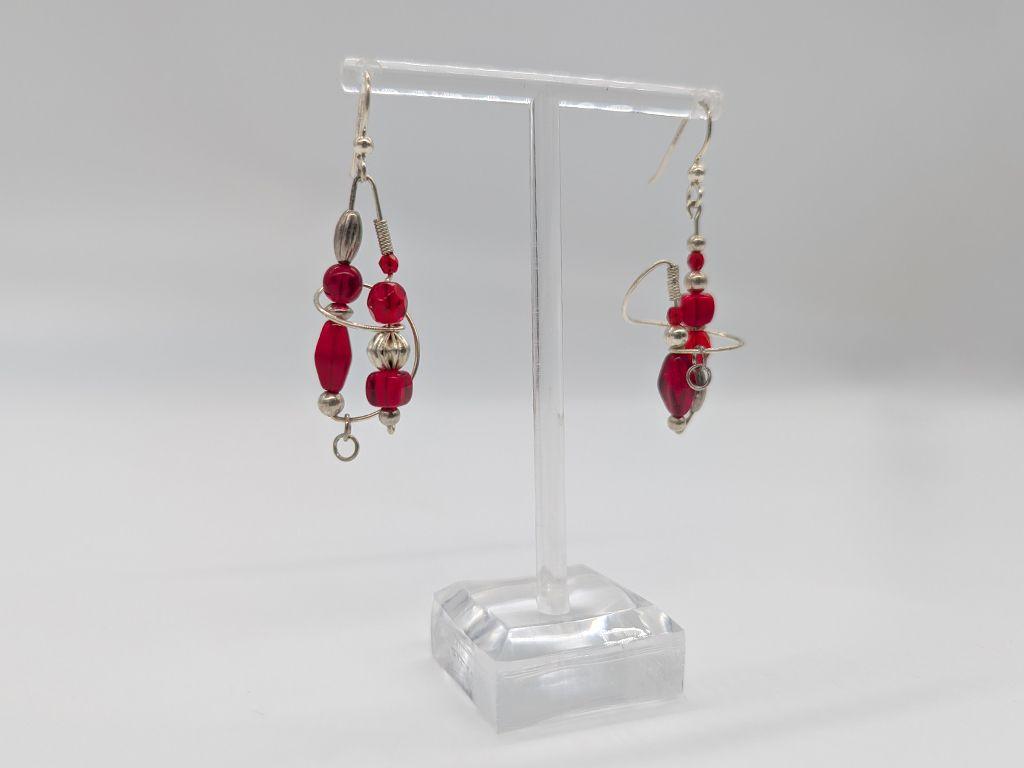 ''Red Asymmetrical Earrings'' by Brian Watson