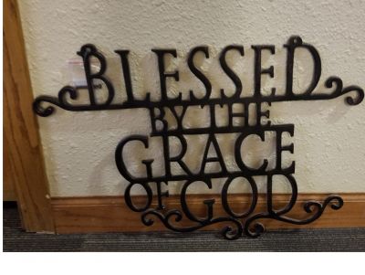 Blessed by the Grace of God hanging wall sign